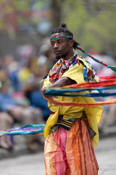 Cleveland, Ohio, USA - June 8, 2019: Parade the Circle, African American man dancing with ribbons during the parade