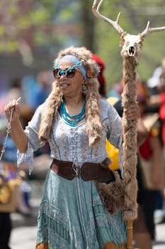 Cleveland, Ohio, USA - June 8, 2019: Parade the Circle, african  american woman wearing traditional clothing holding a batton