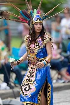 Cleveland, Ohio, USA - June 8, 2019: Parade the Circle, woman and children using aztek outfits dancing.