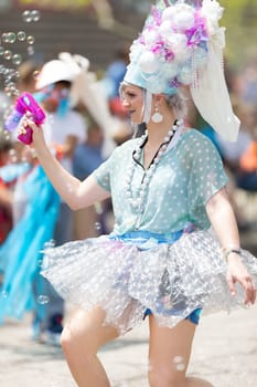 Cleveland, Ohio, USA - June 8, 2019: Parade the Circle, woman using a bubble gun during the parade