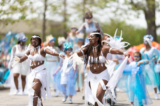 Cleveland, Ohio, USA - June 8, 2019: Parade the Circle, African American woman wearing a colorful outfit, dancing during the parade