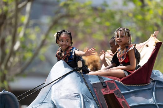 Cleveland, Ohio, USA - June 8, 2019: Parade the Circle, children riding an abstract rino during the parade