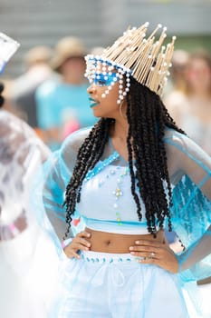 Cleveland, Ohio, USA - June 8, 2019: Parade the Circle, African American woman wearing a colorful outfit, dancing during the parade