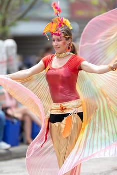Cleveland, Ohio, USA - June 8, 2019: Parade the Circle, women on stilts with outfits with wings at the parade