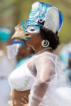 Cleveland, Ohio, USA - June 8, 2019: Parade the Circle, African American woman wearing a colorful outfit, dancing during the parade