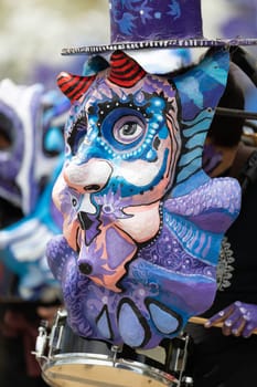 Cleveland, Ohio, USA - June 8, 2019: Parade the Circle, person wearing a large abstract mask, playing the drums