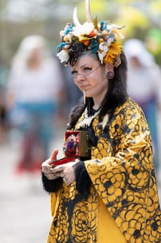 Cleveland, Ohio, USA - June 8, 2019: Parade the Circle, woman wearing a colorful outfit with horns during the parade