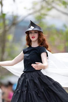 Cleveland, Ohio, USA - June 8, 2019: Parade the Circle, redhead woman on stilts dancing during the parade
