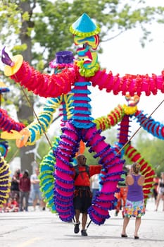 Cleveland, Ohio, USA - June 8, 2019: Parade the Circle, african american man carrying large puppets at the parade