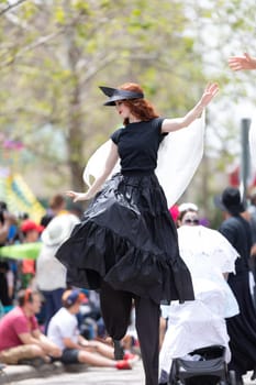 Cleveland, Ohio, USA - June 8, 2019: Parade the Circle, redhead woman on stilts dancing during the parade