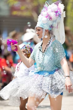 Cleveland, Ohio, USA - June 8, 2019: Parade the Circle, woman using a bubble gun during the parade
