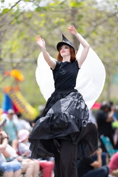 Cleveland, Ohio, USA - June 8, 2019: Parade the Circle, redhead woman on stilts dancing during the parade