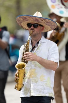 Cleveland, Ohio, USA - June 8, 2019: Parade the Circle, man wearing a sombrero playing the saxophone