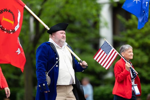 Louisville, Kentucky, USA - May 2, 2019: The Pegasus Parade, Members of the Sons of the American Revolution, wearing traditional clothing marching down the street during the parade