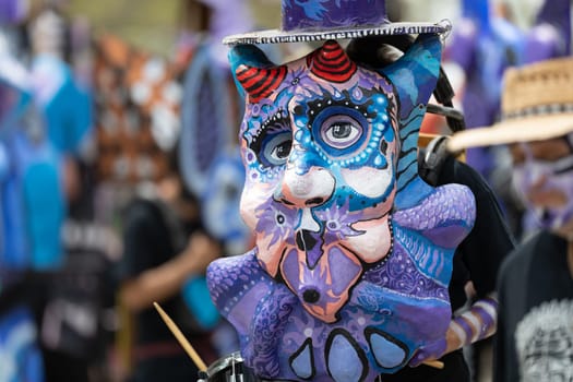 Cleveland, Ohio, USA - June 8, 2019: Parade the Circle, person wearing a large abstract mask, playing the drums
