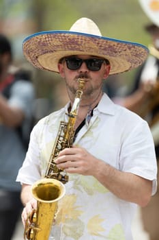 Cleveland, Ohio, USA - June 8, 2019: Parade the Circle, man wearing a sombrero playing the saxophone