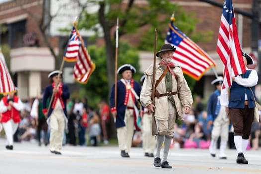 Louisville, Kentucky, USA - May 2, 2019: The Pegasus Parade, Members of the Sons of the American Revolution, wearing traditional clothing marching down the street during the parade