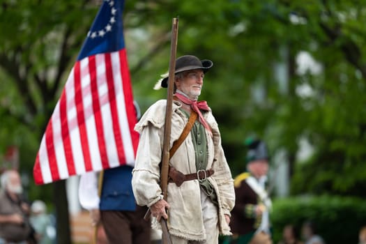 Louisville, Kentucky, USA - May 2, 2019: The Pegasus Parade, Members of the Sons of the American Revolution, wearing traditional clothing marching down the street during the parade