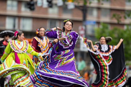 Louisville, Kentucky, USA - May 2, 2019: The Pegasus Parade, Young women and men wearing traditional mexican clothing, dancing during the parade