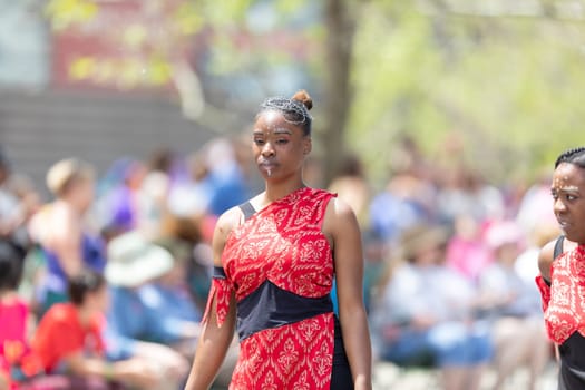Cleveland, Ohio, USA - June 8, 2019: Parade the Circle, African American woman dancer, wearing a red outfit and face paint