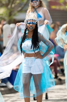 Cleveland, Ohio, USA - June 8, 2019: Parade the Circle, African American woman wearing a colorful outfit, dancing during the parade