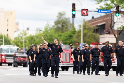 Louisville, Kentucky, USA - May 2, 2019: The Pegasus Parade, Members of the fire department marching down the street during the parade