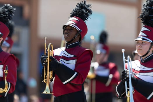 Benton Harbor, Michigan, USA - May 4, 2019: Blossomtime Festival Grand Floral Parade, Members of the Watervliet High School Marching Band performing at the parade