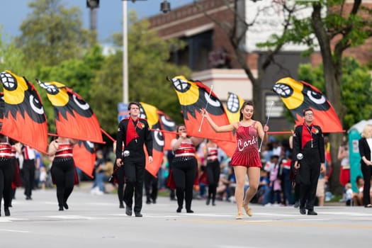 Louisville, Kentucky, USA - May 2, 2019: The Pegasus Parade, Members of the University of Louisville cheerleaders and marching band performing at the parade