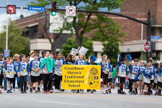 Louisville, Kentucky, USA - May 2, 2019: The Pegasus Parade, Members of the Greathouse Shryock Traditional Elementary School, carrying hunger awareness signs during the parade
