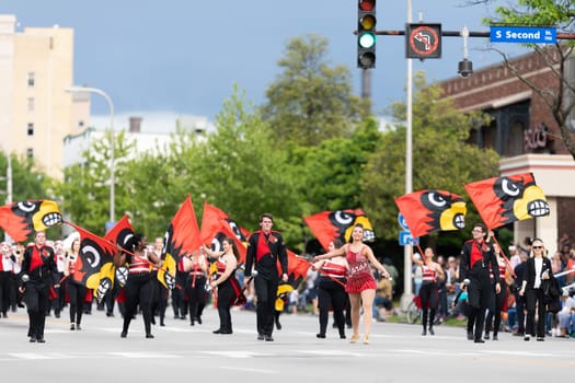 Louisville, Kentucky, USA - May 2, 2019: The Pegasus Parade, Members of the University of Louisville cheerleaders and marching band performing at the parade