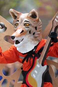 Cleveland, Ohio, USA - June 8, 2019: Parade the Circle, person dress up as a fox with butterflie wings and playing a guitar