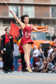 Louisville, Kentucky, USA - May 2, 2019: The Pegasus Parade, Members of the University of Louisville cheerleaders and marching band performing at the parade