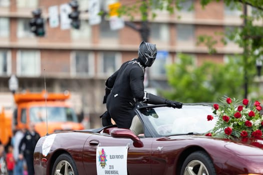 Louisville, Kentucky, USA - May 2, 2019: The Pegasus Parade, Man dress up as black panther on a car during the parade
