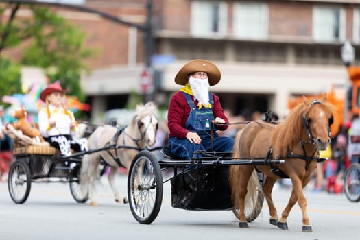 Louisville, Kentucky, USA - May 2, 2019: The Pegasus Parade, Women dress up as toy story characters, riding carriages pulled by ponys during the parade