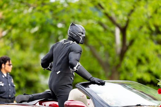 Louisville, Kentucky, USA - May 2, 2019: The Pegasus Parade, Man dress up as black panther on a car during the parade