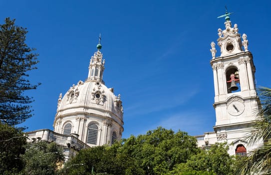 Dome and clock tower of the late Baroque and Neo-Classical Royal Basilica and Convent of the Most Sacred Heart of Jesus, built in late 18th century in Lisbon, Portugal