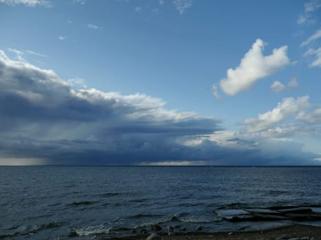 low dark rain clouds over the sea
