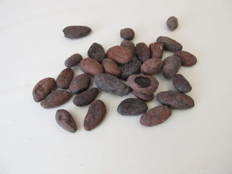 Roasted cocoa beans on a wooden board