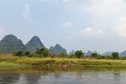 View of the picturesque mountains from the river, Yangshuo, China, Asia