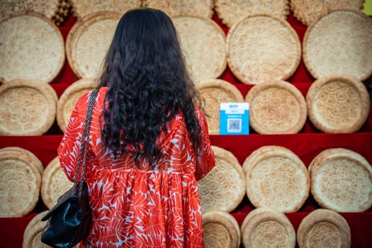 Xian, China -  July 2019 : Woman looking at the display with bread and bakery products on the street in the Muslim Quarter
