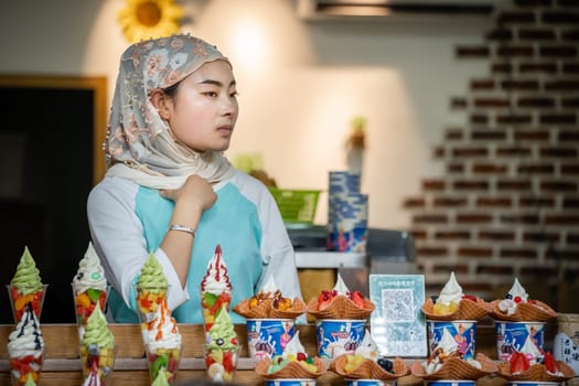 Xian, China -  July 2019 : Muslim woman selling ice cream like dessert with pieces of fresh fruits for sale on the food street in the Muslim Quarter