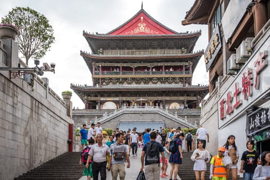 Xian, China -  July 2019 : People climbing up the stairs leading to the landmark Drum Tower in the city Xian, Shaaxi Province