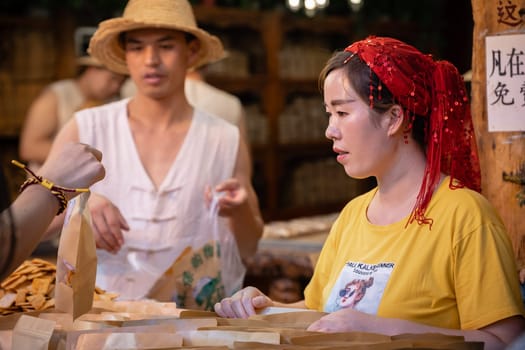 Xian, China -  July 2019 : Traditional local food vendor selling snacks on the street in the Muslim Quarter