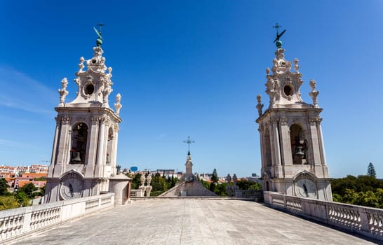 The double clock tower of the late Baroque and Neo-Classical Royal Basilica and Convent of the Most Sacred Heart of Jesus, built in late 18th century in Lisbon, Portugal