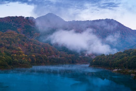 Morning Mist with Autumn Fall Lake and Forest at Tamagawa Dam in Akita Tohoku Japan
