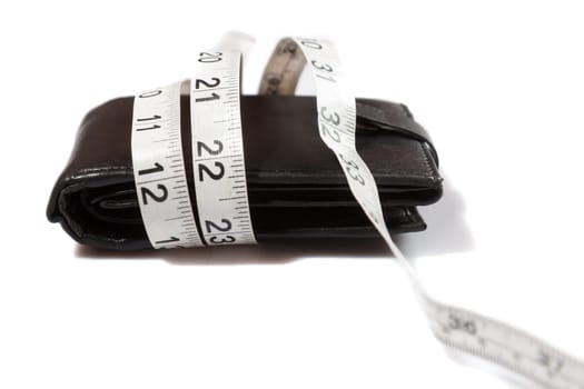 concept of budget and money. Purse is tied with measuring tape on white background