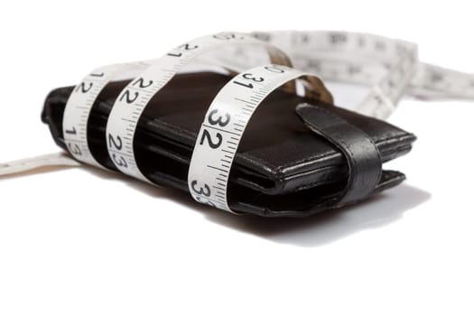 concept of budget and money. Purse is tied with measuring tape on white background
