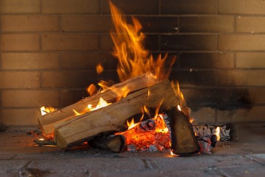 Close up shot of burning firewood in the fireplace.