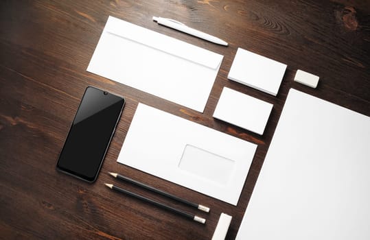 Photo of blank stationery set on wooden background. Corporate identity mock up for placing your design.