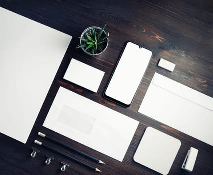 Blank corporate stationery template on wood table background. Responsive design mockup.